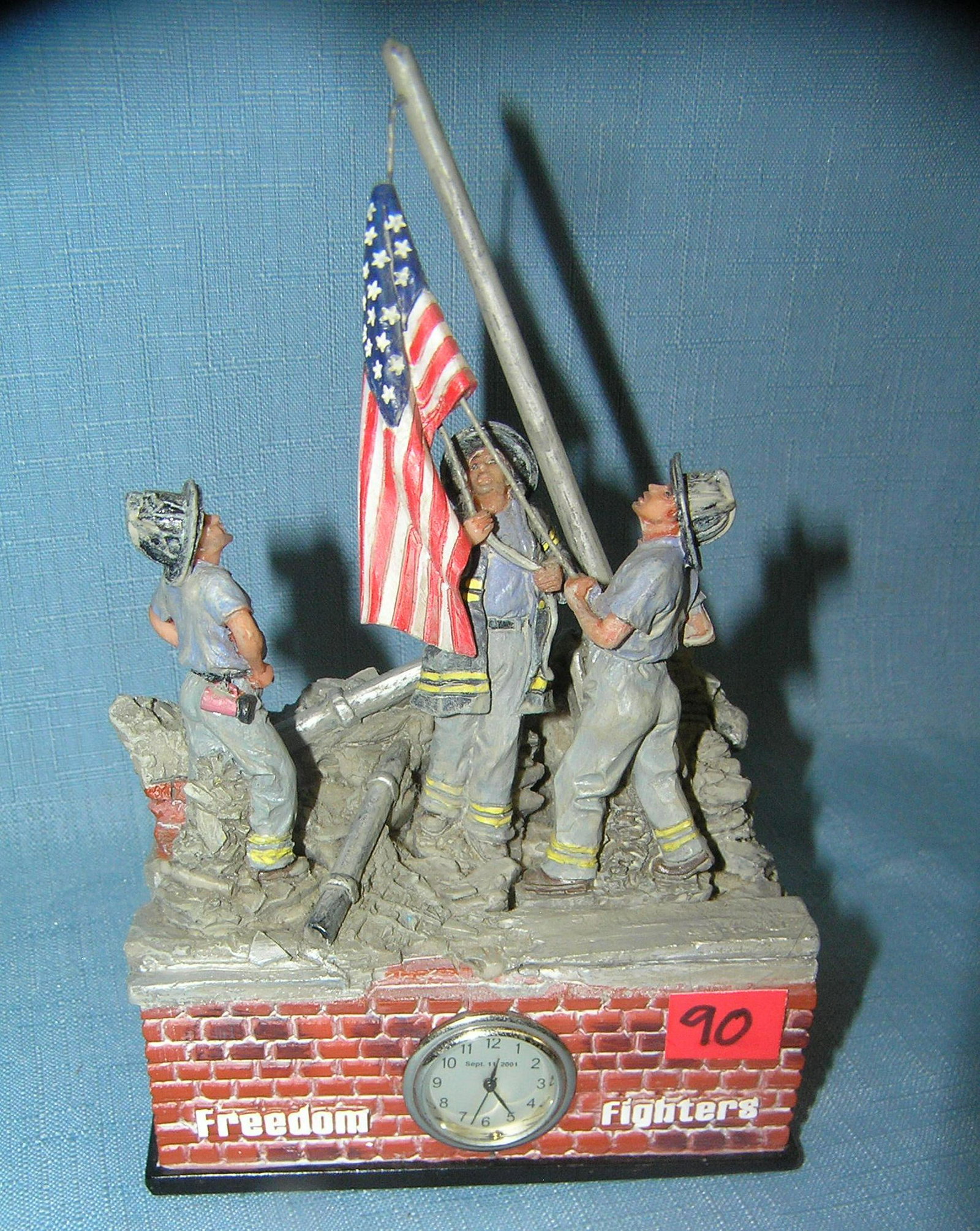 Freedom fighters 9/11 commemorative piece: Freedom fighters America's pride 9/11 commemorative piece features FDNY fire fighters raising the American flag also has a built in clock inscription on rear and felt based est. value $40.00-$50.00