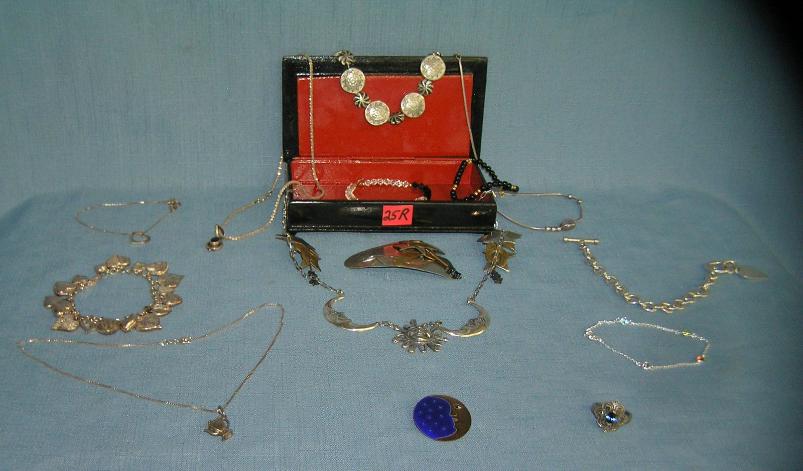 Russian laquer jewelry box loaded with vintage jewelry: Hand painted Russian laquer jewelry box loaded with vintage sterling silver and gold clasp jewelry this lot may also contain some silver plate from the estate of retired realtor Marie Saraceni part of