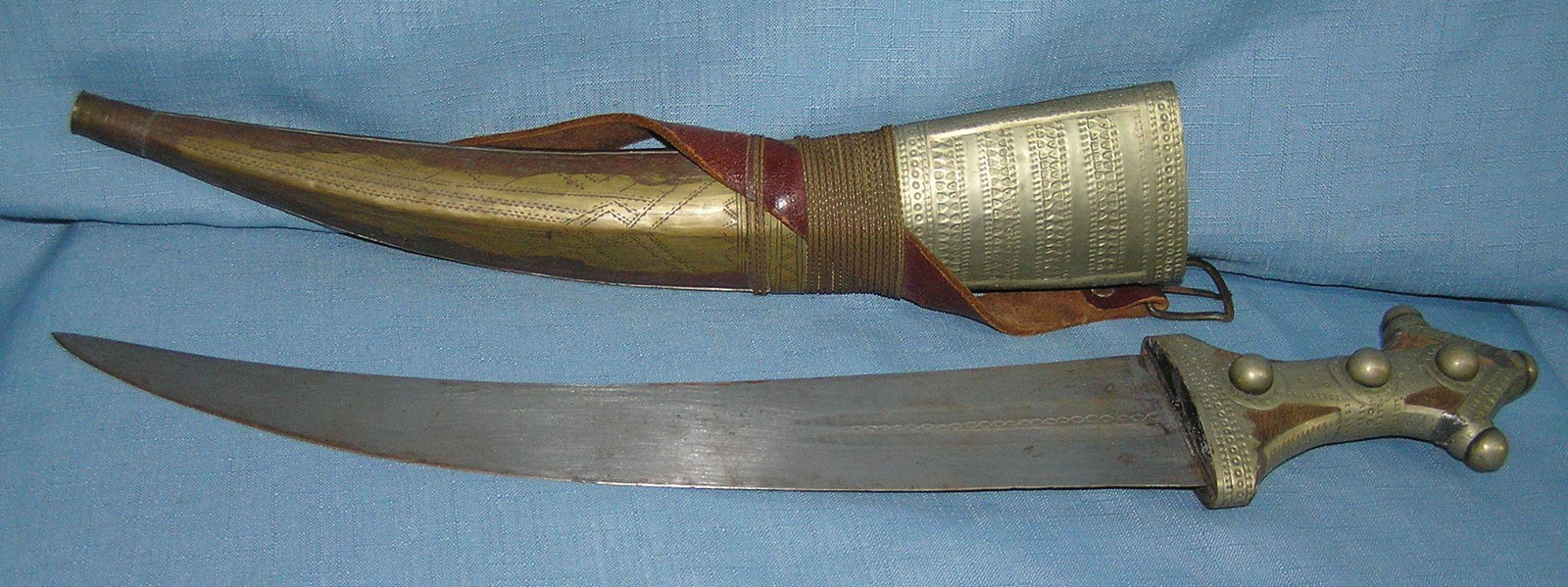 Large antique Arabian fighting dagger: Large antique Arabian fighting dagger, steel blade with brass and nickel handle and case high quality brass braiding holds leather strap in place est. value $325.00-$350.00