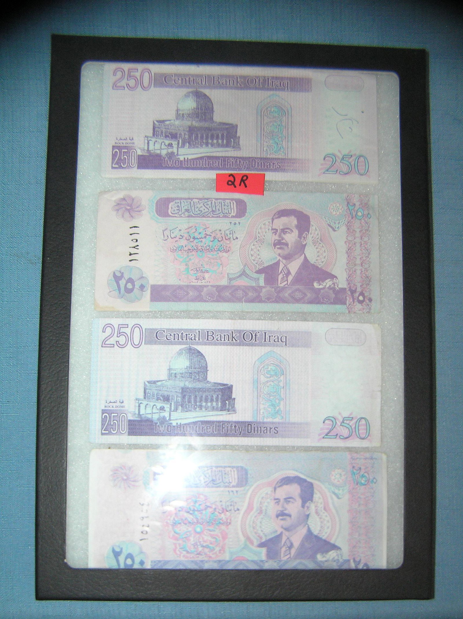 Iraqui currency featuring Saddam Hussien: Collection of Iraqui currency featuring Saddam Hussien est. value $40.00-$50.00