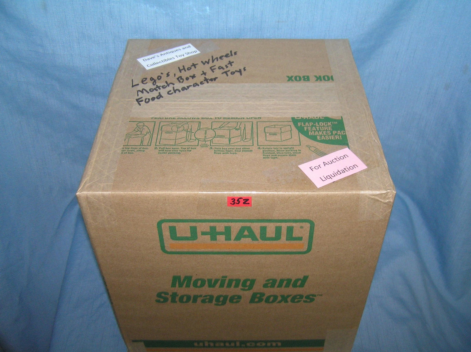 Moving and Storage Company mystery box lot marked: Moving and Storage Company mystery box lot marked Dave's Antiques and Collectibles Toy Shop marked Lego's, Hot Wheels, Match Box and fast food character toys part of a moving and storage company seize
