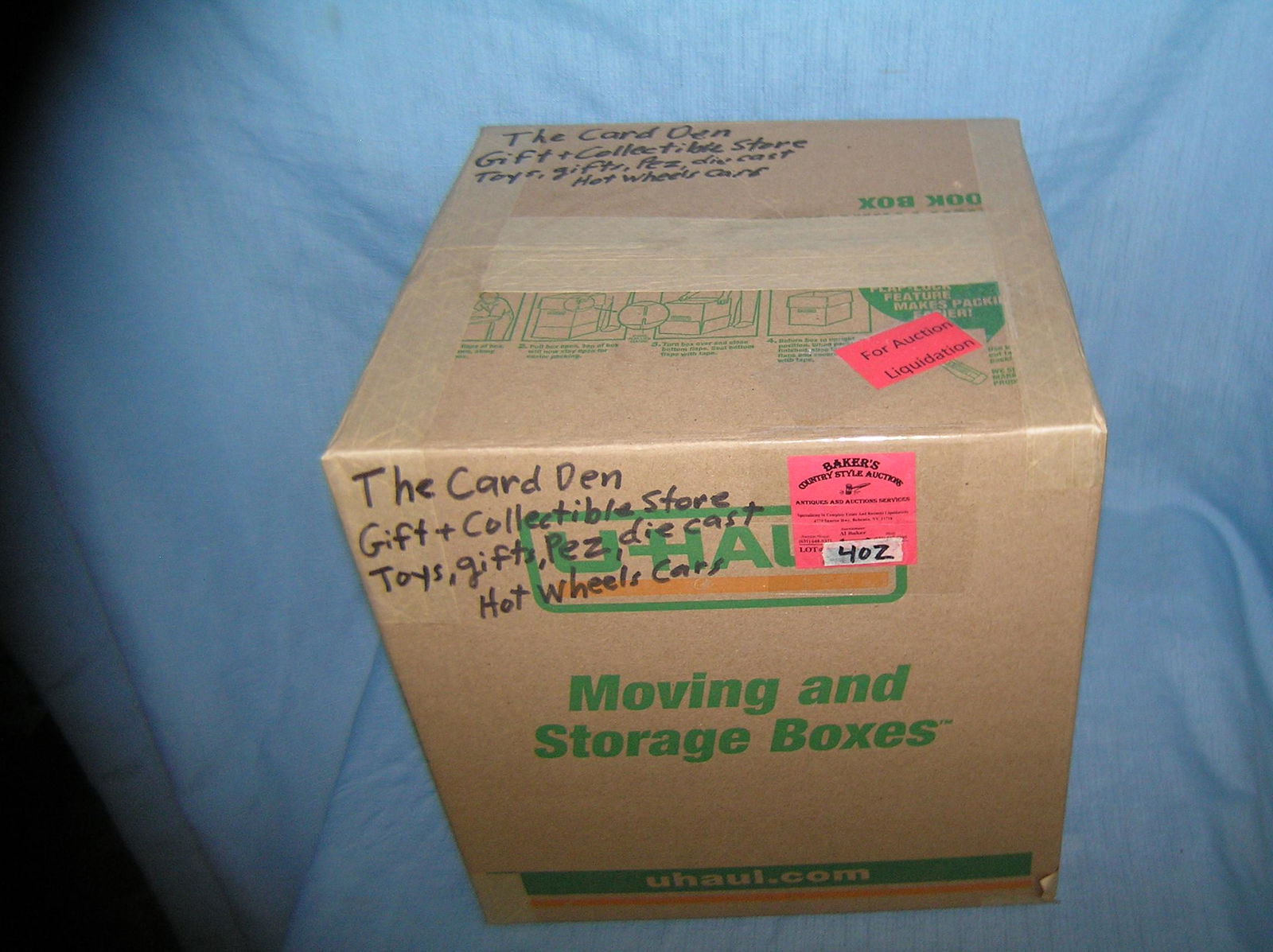 Moving and Storage Company mystery box lot marked The: Moving and Storage Company mystery box lot marked The Card Den Gift and Collectible's store includes toys, gifts, Pez, die cast and Hot Wheel's cars part of a moving and storage company seized or uncl