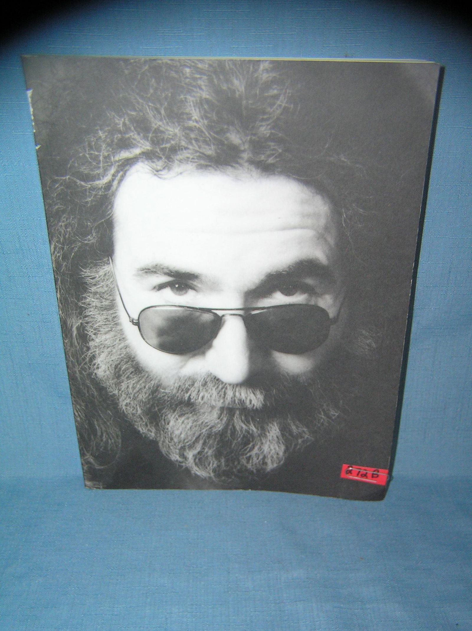 Jerry Garcia photo illustrated paper back book: Jerry Garcia first paper back edition by the editors Rolling Stone produced by Little Brown and Company photo illustrated showing and telling the history of his career est. value $35.00-$40.00