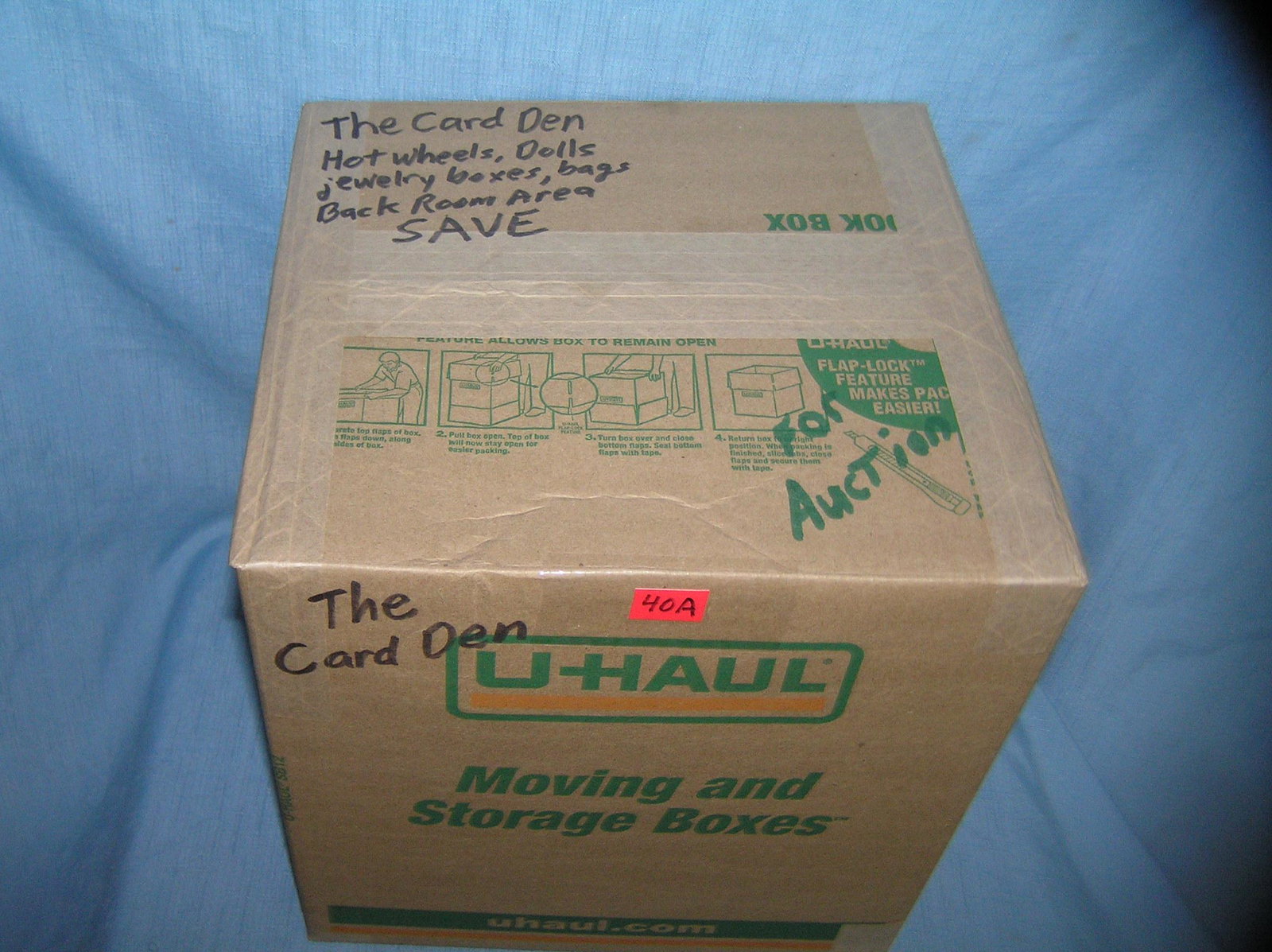 Moving and Storage Company mystery box lot: Moving and Storage Company mystery box lot marked Card Den cards and collectibles, Hot Wheels cars, dolls, jewelry boxesand bags, backroom area part of a moving and storage company seized or unclaimed