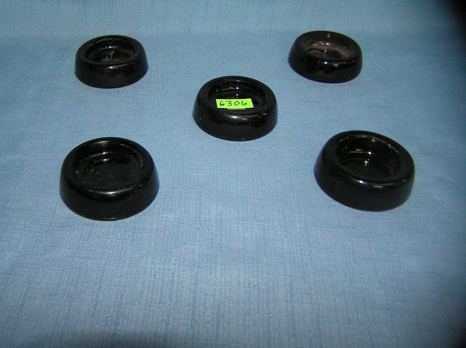 Group of 5 dark amber Depression glass furniture: Group of 5 dark amber Depression glass furniture coasters est. value $30.00-$50.00