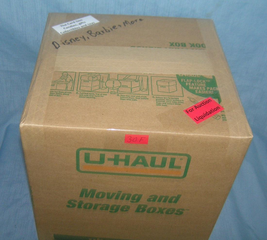 Moving and Storage Company mystery box lot: Moving and Storage Company mystery box lot marked The Card Den, candies, gifts, collectibles and Toys; Disney, Barbie and more part of a moving and storage company seized or unclaimed merchandise grou