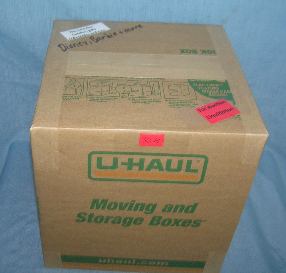 Moving and Storage Company mystery box lot: Moving and Storage Company mystery box lot marked The Card Den, candies, gifts, collectibles and Toys; Disney, Barbie and more part of a moving and storage company seized or unclaimed merchandise grou