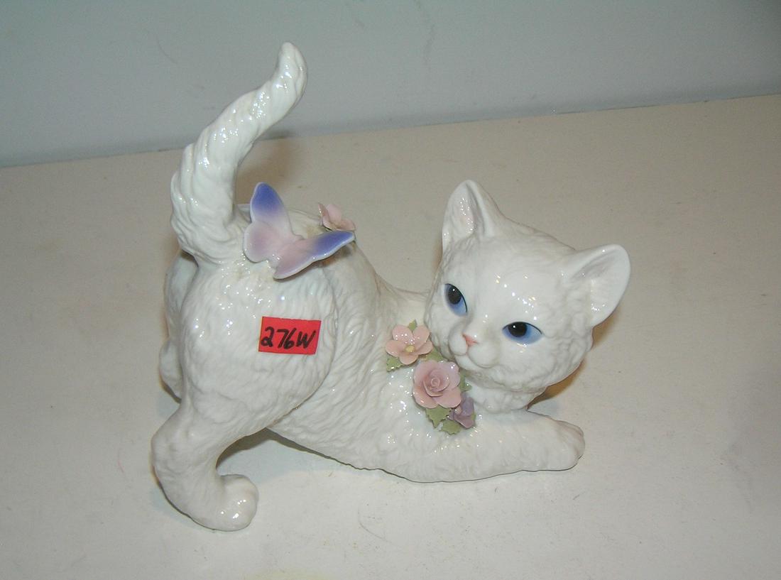 Hand painted porcelain windup musical cat: Hand painted porcelain windup musical cat with butterfly and floral decoration est. value $75.00-$100.00