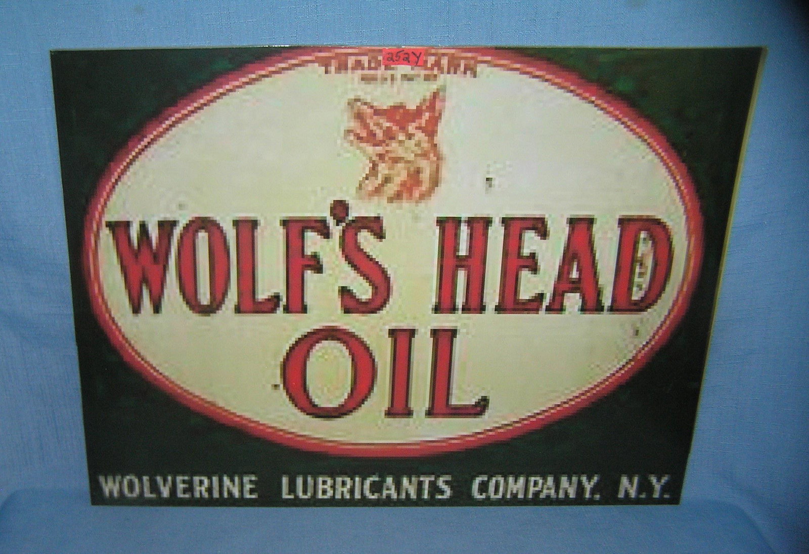 Wolf's Head oil retro style advertising sign: Wolf's Head oil retro style advertising sign 12 inches by 16 inches on board est. value $40.00-$50.00