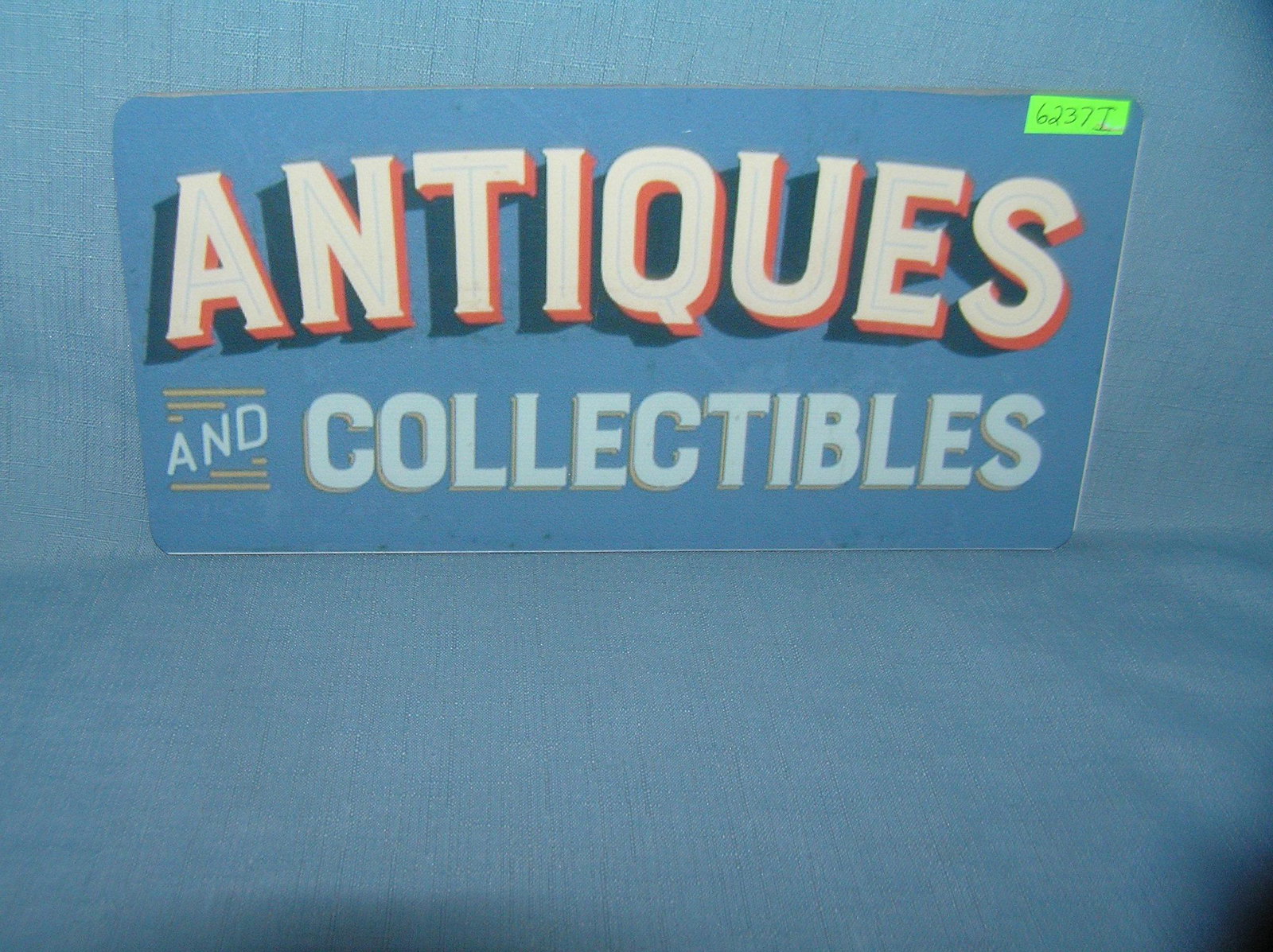 Antiques and collectibles License plate size sign: Antiques and collectibles License plate size wall or car advertising sign est. value $25.00-$30.00