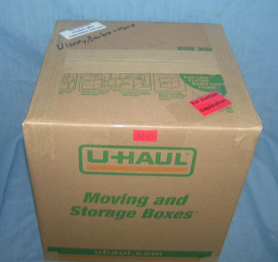 Moving and Storage Company mystery box lot: Moving and Storage Company mystery box lot marked The Card Den, candies, gifts, collectibles and Toys; Disney, Barbie and more part of a moving and storage company seized or unclaimed merchandise grou