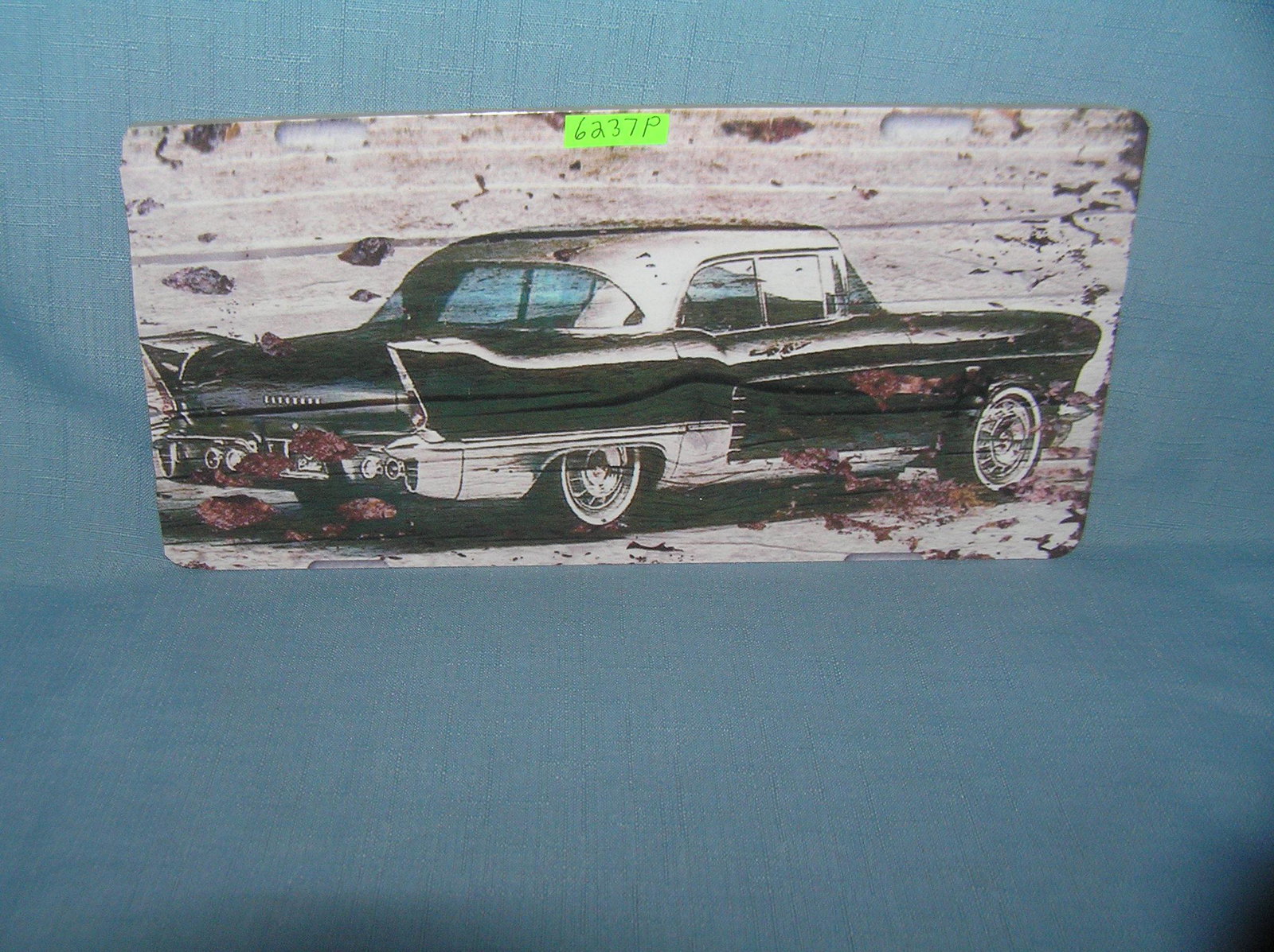 Vintage 50's automobile License plate size sign: Vintage 50's automobile License plate size wall or car advertising sign est. value $25.00-$30.00