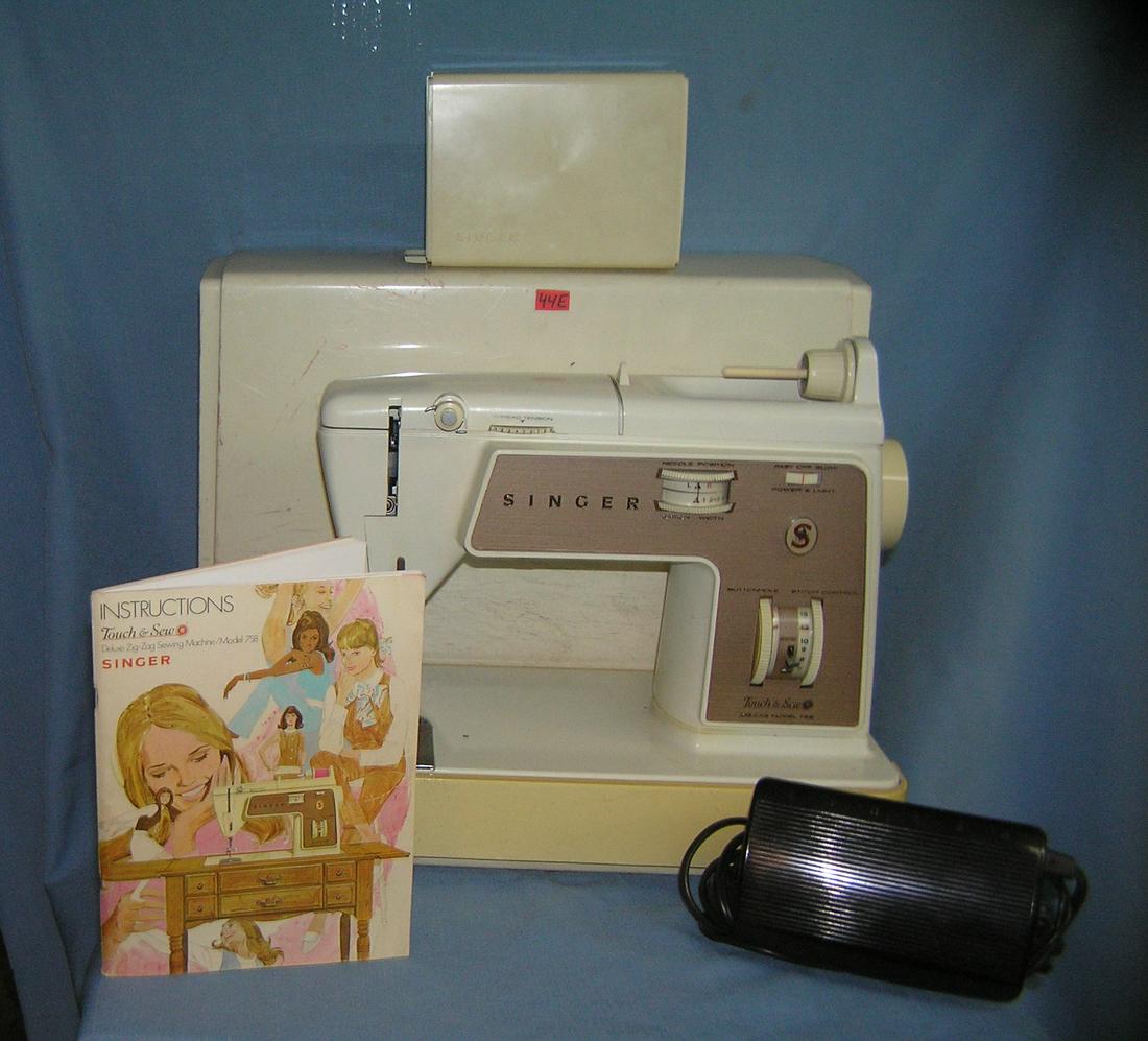 Singer touch and sew deluxe zig zag sewing machine: Vintage Singer touch and sew deluxe zig zag sewing machine model number 758 complete with all attatchments, foot pedal, instruction booklet and carrying case est. value $200.00-$215.00