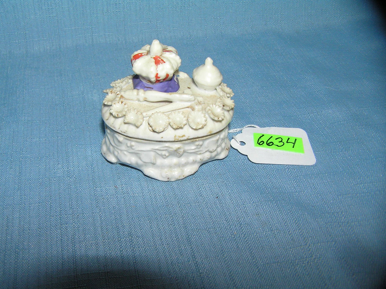 Higher end religious decorative trinket box: Higher end religious decorative trinket box featuring cross, crown and other religious artifacts on this decorative porcelain box est. value $50.00-$60.00