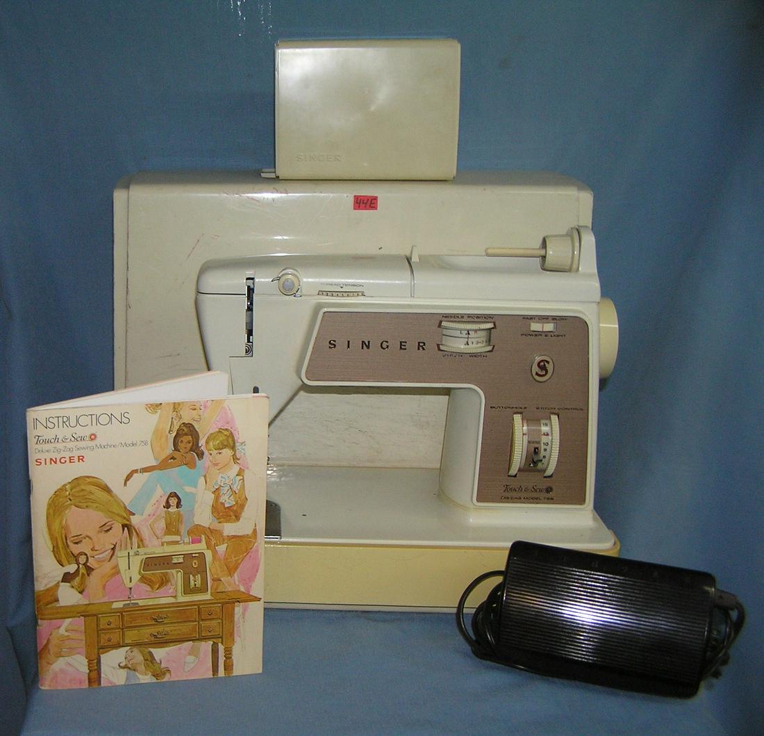 Singer touch and sew deluxe zig zag sewing machine: Vintage Singer touch and sew deluxe zig zag sewing machine model number 758 complete with all attatchments, foot pedal, instruction booklet and carrying case est. value $200.00-$215.00