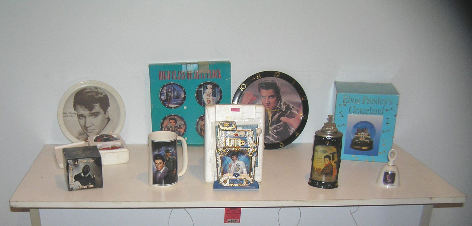Large group of Elvis Presley collectibles: Elvis Presley collectibles this large group includes a beer stein, mug, slot machine plaque, clocks, snow globe, bell, plate and more est. value $125.00-$150.00
