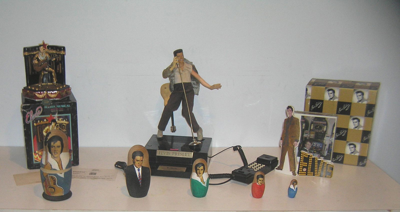 Elvis Presley collectibles collection: Elvis Presley collectibles collection includes rare figural phone, figural music box, Elvis stand up display piece and 5 piece nesting doll set est. value $300.00-$350.00