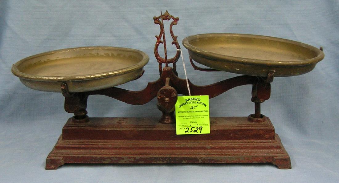 Antique cast iron scale with dual brass bins: Antique cast iron scale with dual brass bins est. value $200.00-$250.00