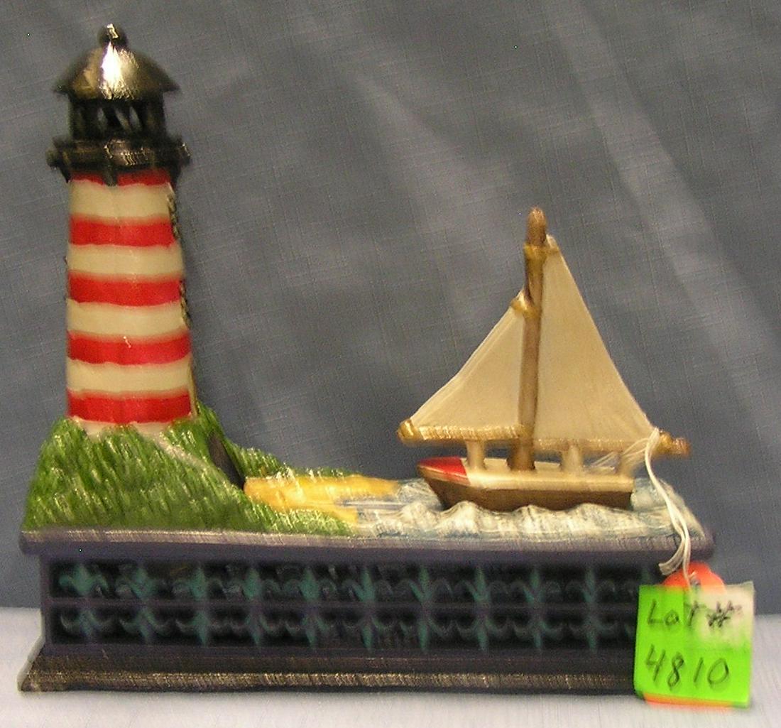 Sail Boat and Lighthouse mechanical bank: Vintage all hand painted cast iron Sail Boat and Lighthouse mechanical bank circa 1970’s $350.00-$375.00