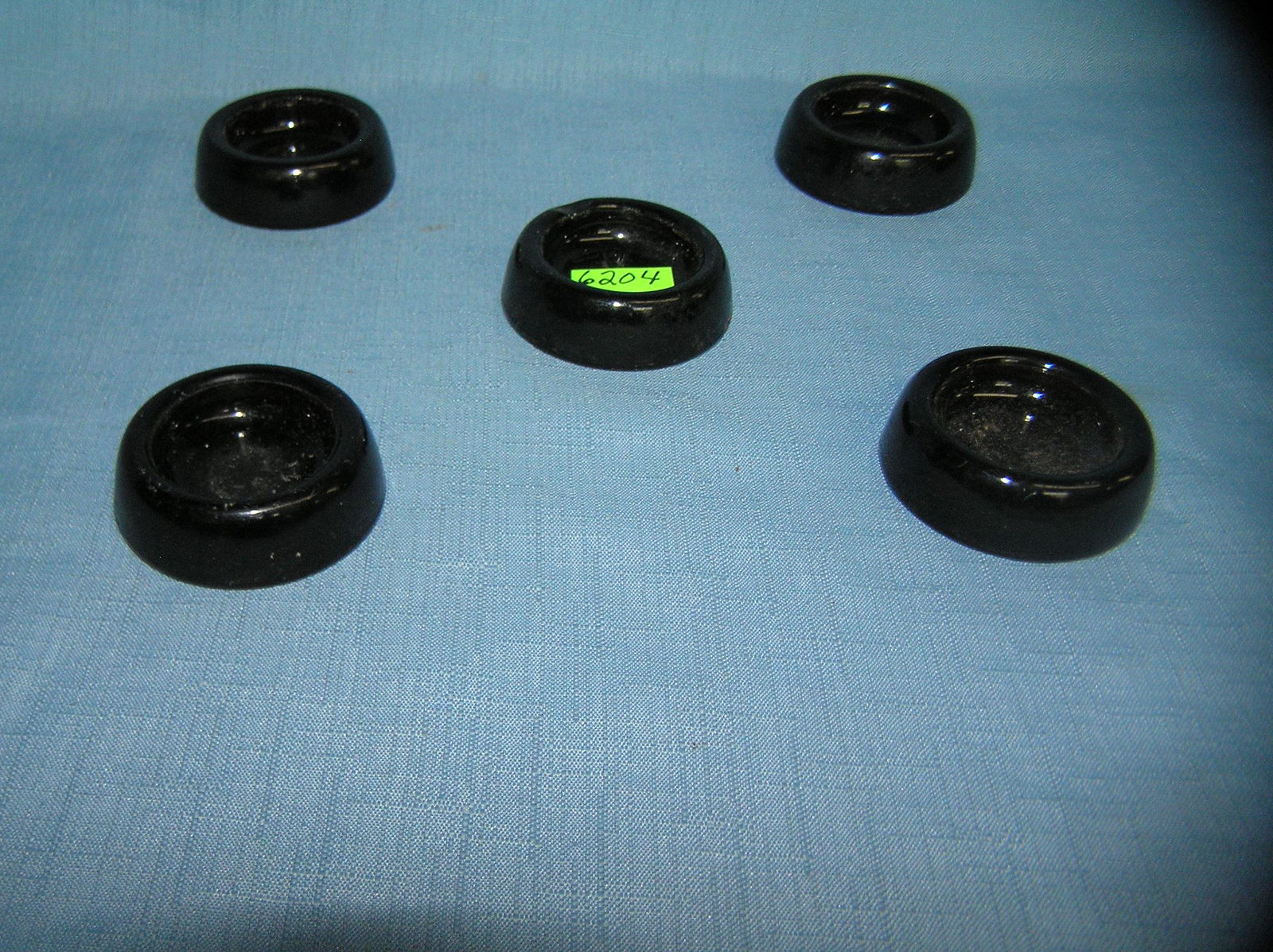 Group of 5 dark amber Depression glass furniture: Group of 5 dark amber Depression glass furniture coasters est. value $30.00-$50.00