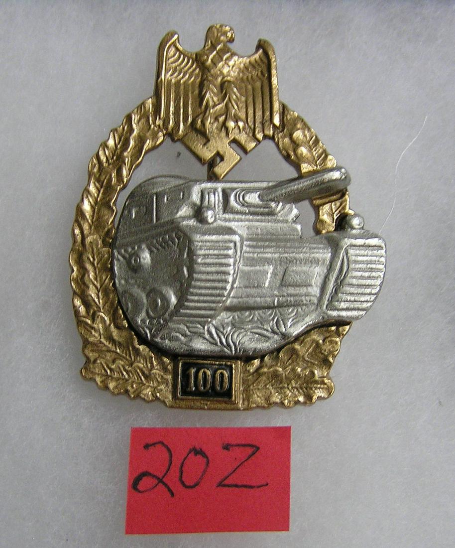 German Army tank battle badge 100 actions WWII style: German Army tank battle badge 100 actions gold and silver colored WWII style high quality reproduction collectors, re-enactors,historical or theatrical collectors piece est. value $65.00-$75.00