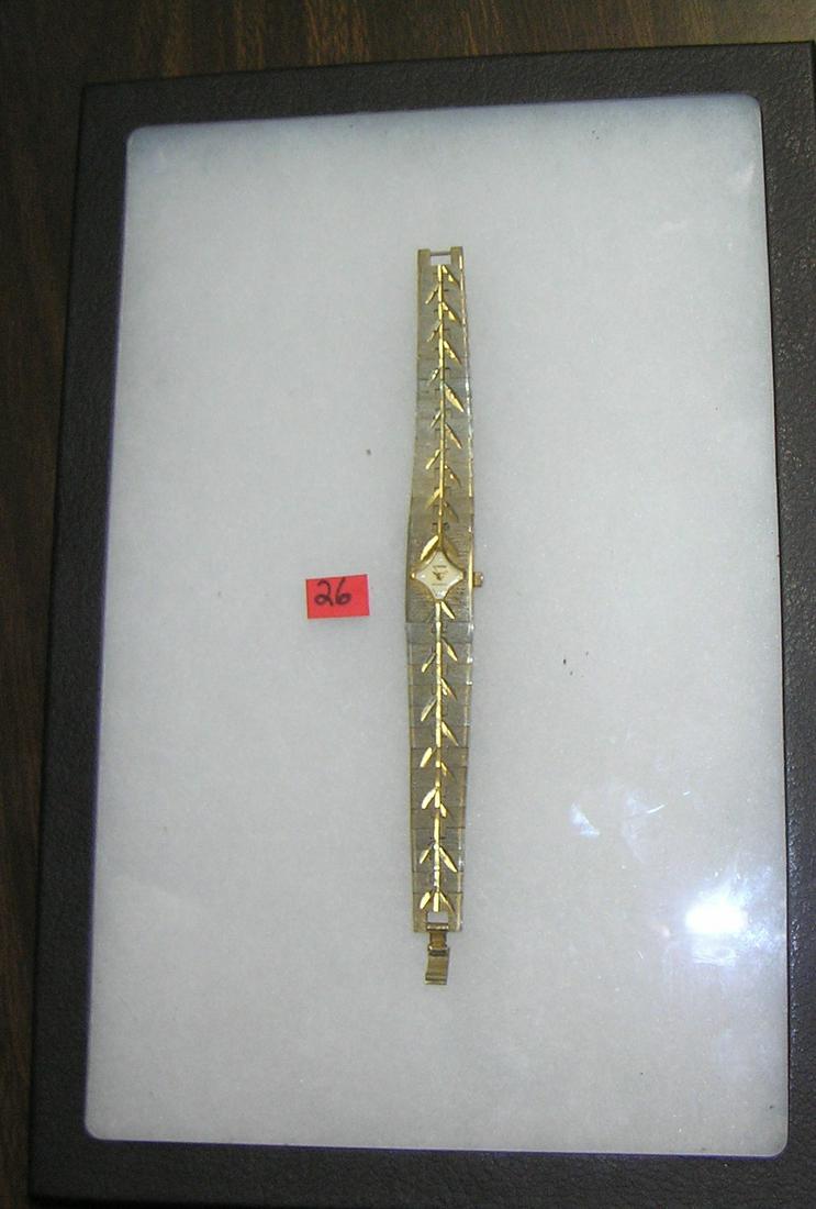Cyrano gold toned wrist watch: Cyrano gold toned wrist watch with 4 simulated diamond stones in face est. value $50.00-$60.00