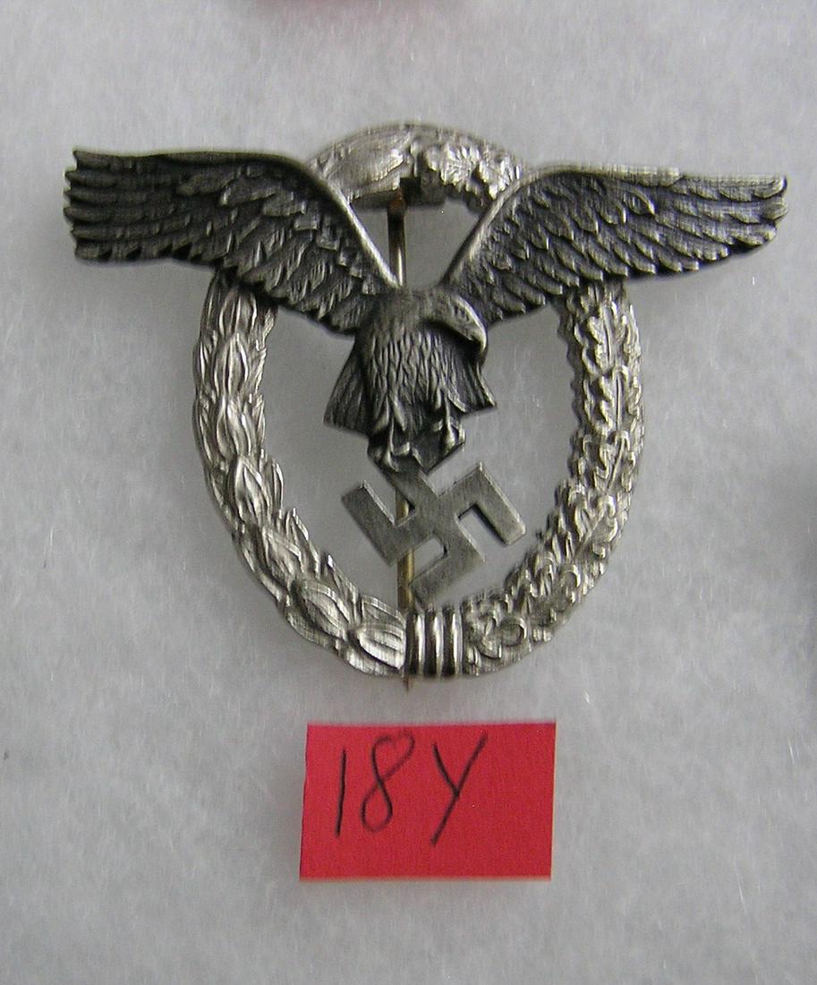 German pilots badge WWII style: German pilots badge silver wreath with antique silver eagle color WWII style high quality reproduction collectors, re-enactors,historical or theatrical collectors piece est. value $80.00-$100.00