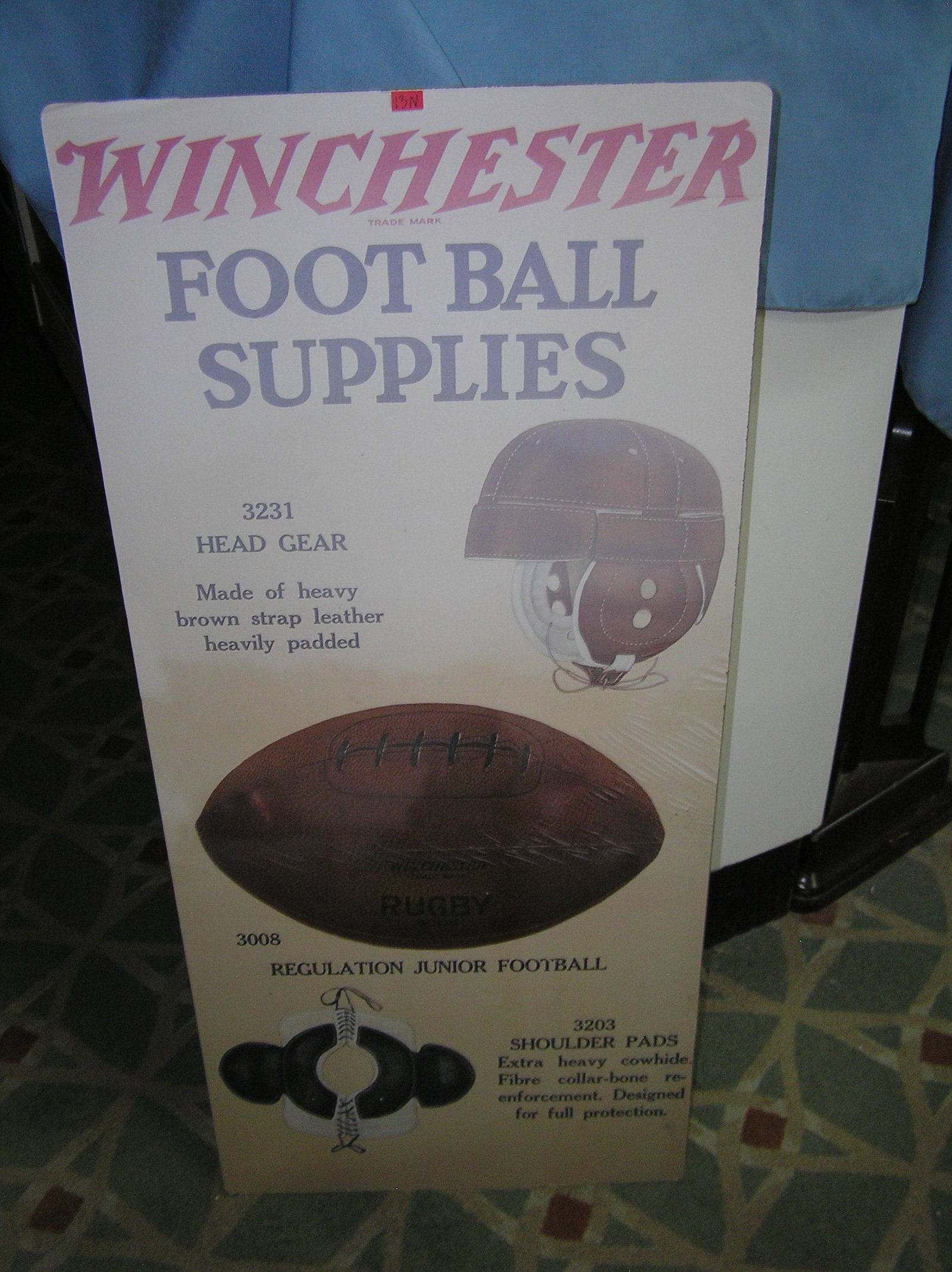 Winchester football supplies retro style advertising: Winchester football supplies retro style advertising sign large 18 1/2 inches by 40 inches printed on masonite board est. value $350.00-$450.00