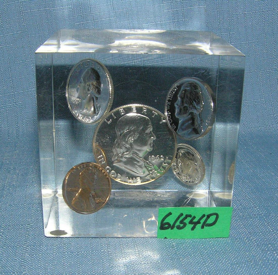 Group of proof coins in a Lucite paper weight: Group of proof silver, clad and copper proof coins in a Lucite paper weight est. value $40.00-$50.00