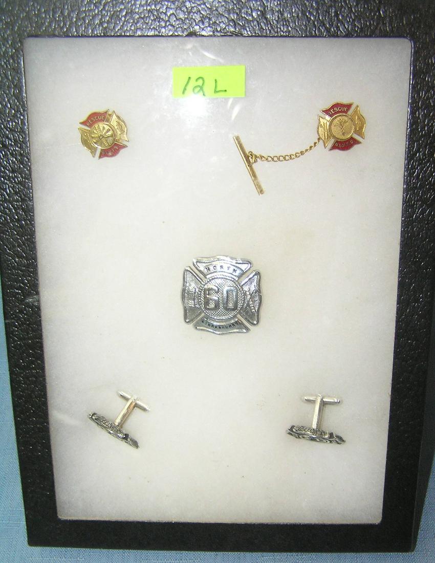 Group of Fire Dept collectibles: Group of Fire Dept collectibles includes badge, cuff links, tie pin and collar pin est. value $75.00-$80.00