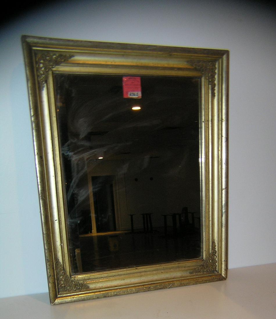 Antique gold gilded wall mirror circa 1880's: Antique gold gilded wall mirror circa 1880's with fancy gold and metal filigree corners 23 inches by 28 inches est. value $225.00-$250.00