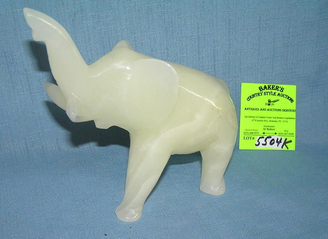 Alabaster elephant with upraised trunk: Alabaster elephant with upraised trunk est. value $40.00-$50.00