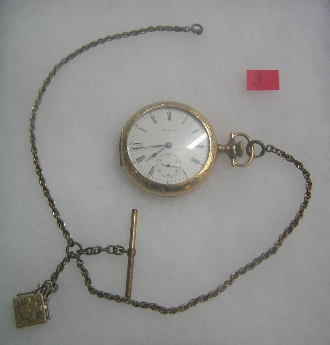 Antique Elgin pocket watch: Antique Elgin pocket watch with minuite and second hand dials in gold filled case, 15 jewels, case dated 1909 with baby photo watch, also has watch chain and locket fob est. value $500.00-$600.00