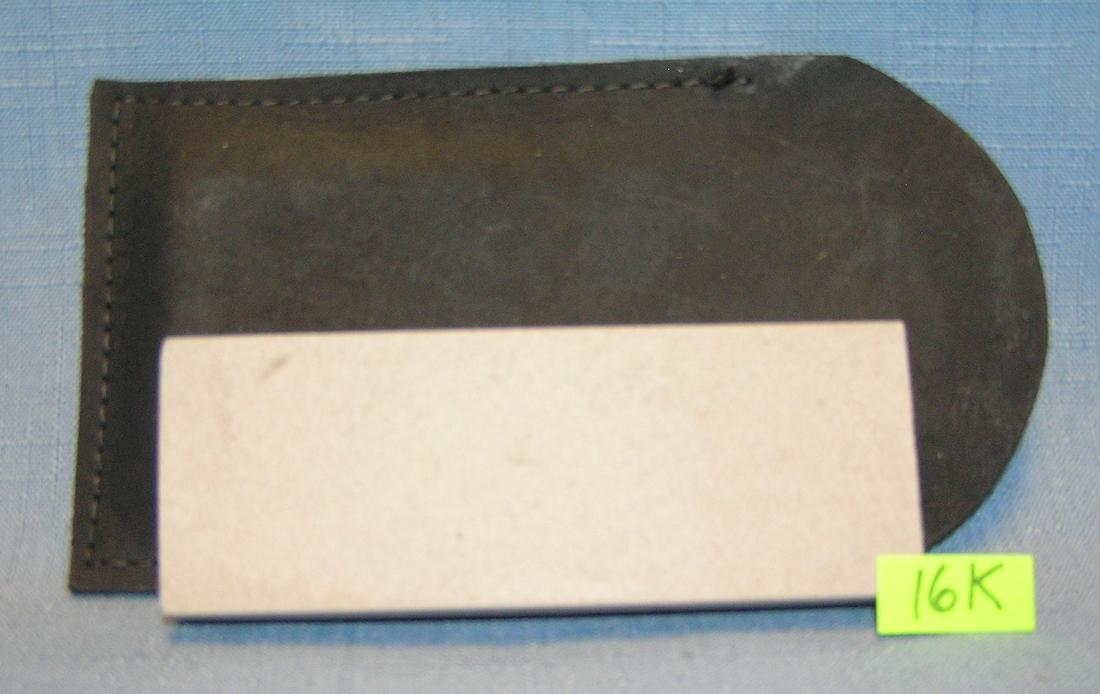 Genuine oil stone knife sharpening stone: Genuine oil stone knife sharpening stone with hand stitched case est. value $30.00-$35.00