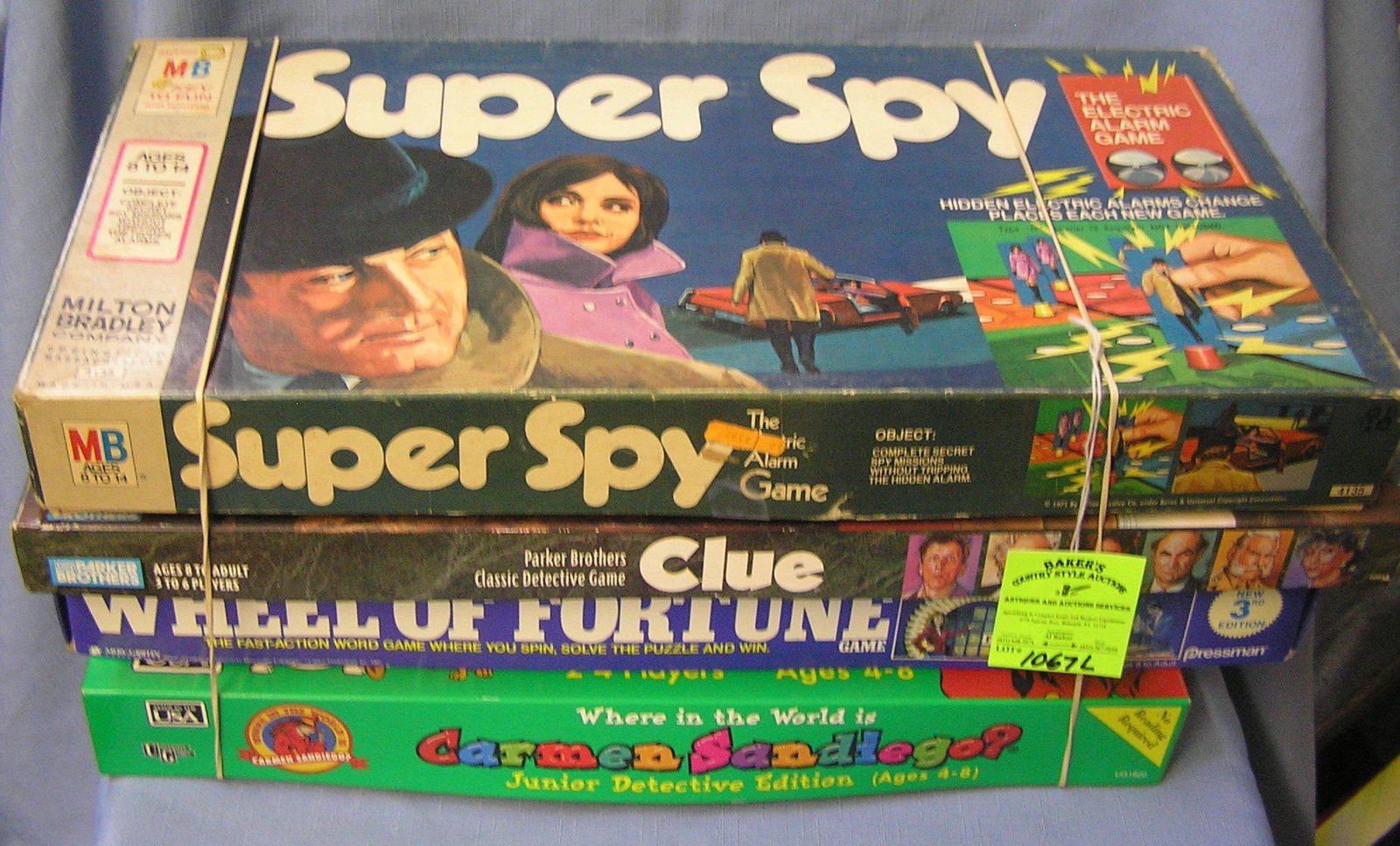Group of 4 vintage board games: Group of 4 vintage board games includes Super Spy, Cue, Wheel of Fortune and Where in the World is Carmen Sandiego? est. value $40.00-$45.00