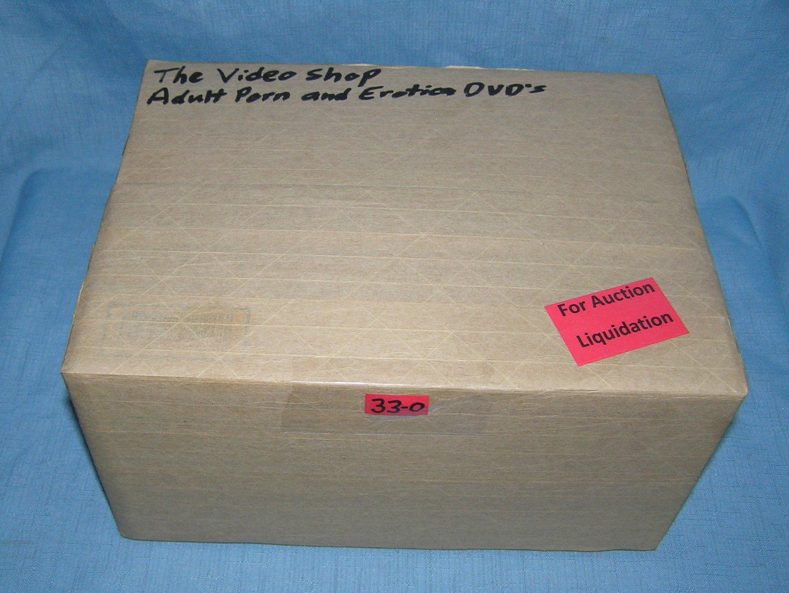 Moving and Storage Company mystery box lot marked The Video Shop: Moving and Storage Company mystery box lot marked The Video Shop: Adult Porn and Erotica DVD'S part of a moving and storage company seized or unclaimed merchandise group sent to auction for liquidatio