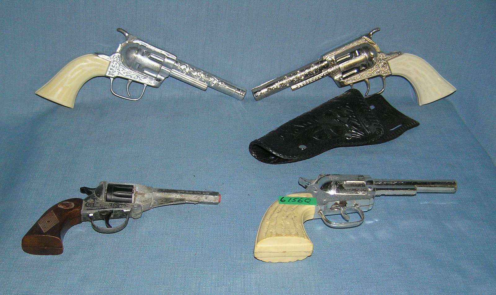 Group of vintage western themed cap guns: Group of vintage western themed cap guns includes 1 with a holster est. value $200.00-$250.00