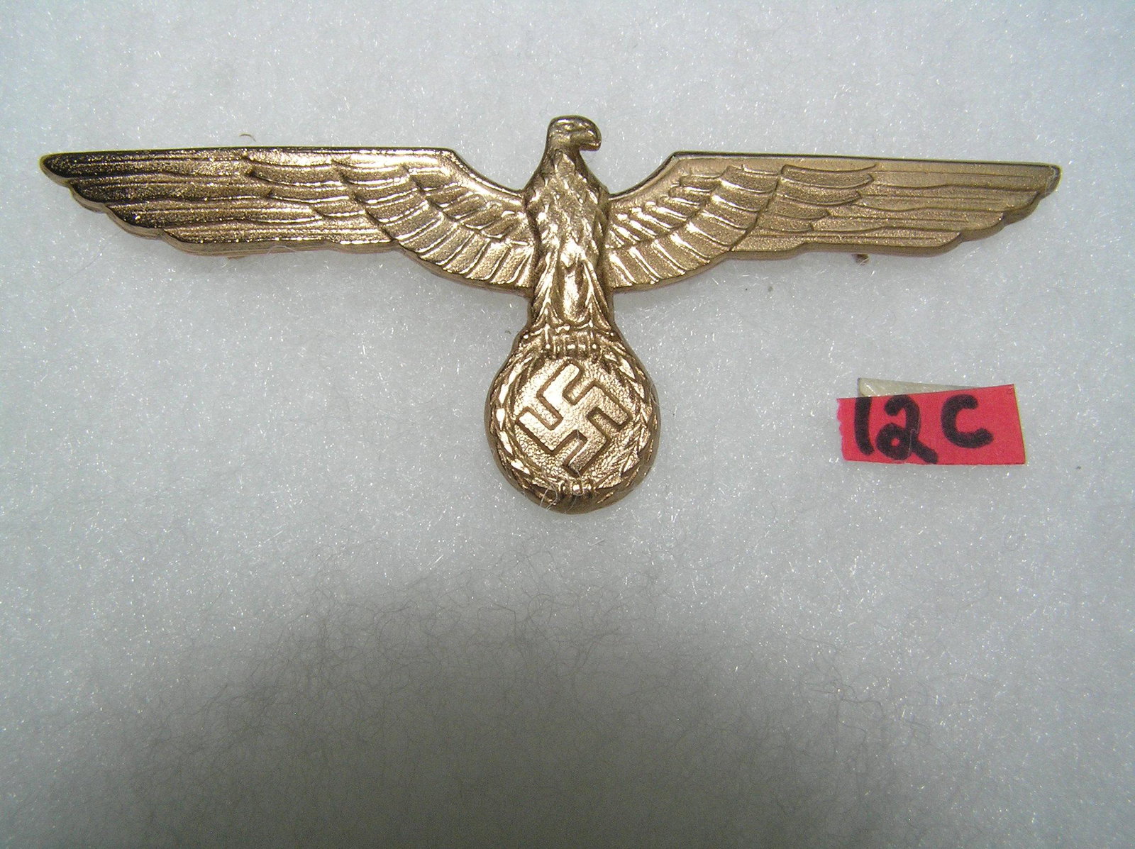 German army breast eagle WWII style: German army breast eagle gold colored with pin back WWII style high quality reproduction collectors, re-enactors,historical or theatrical collectors piece est. value $80.00-$100.00