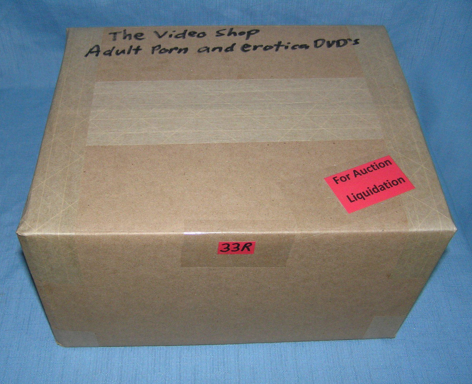 Moving and Storage Company mystery box lot marked The Video Shop: Moving and Storage Company mystery box lot marked The Video Shop: Adult Porn and Erotica Movies part of a moving and storage company seized or unclaimed merchandise group sent to auction for liquidati