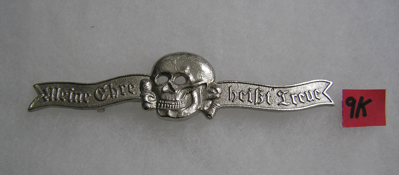 German SS dining jacket skull bar badge WWII style: German SS dining jacket skull bar badge silver colored with pin back WWII style high quality reproduction collectors, re-enactors,historical or theatrical collectors piece est. value $80.00-$100.00