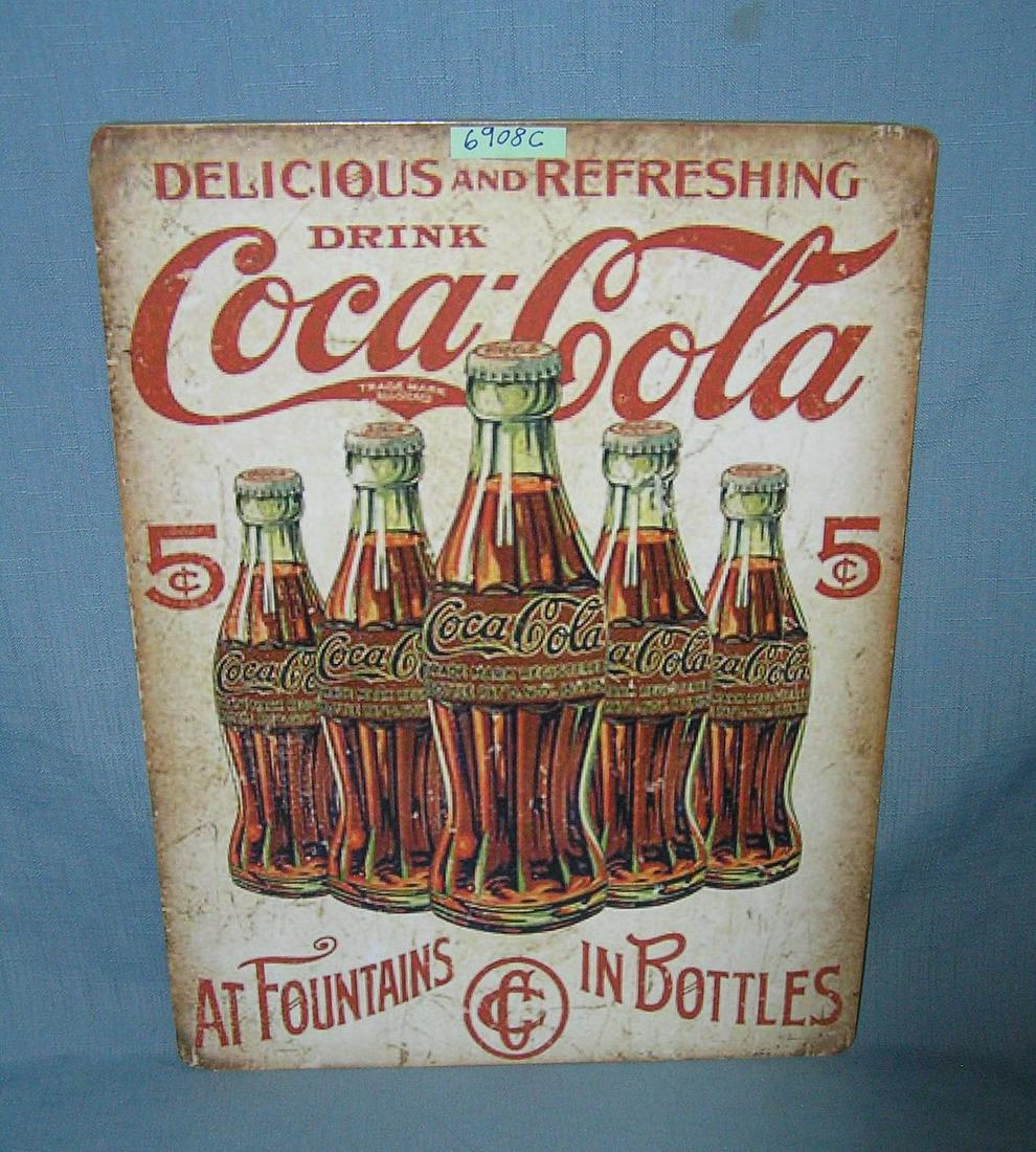 Drink Coca Cola at foundations and in bottles style advertising sign: Drink Coca Cola at foundations and in bottles style advertising sign printed on PVC hardboard these signs are auctioned for their decorative and display purposes 12 inches by 16 inches est. value $40.
