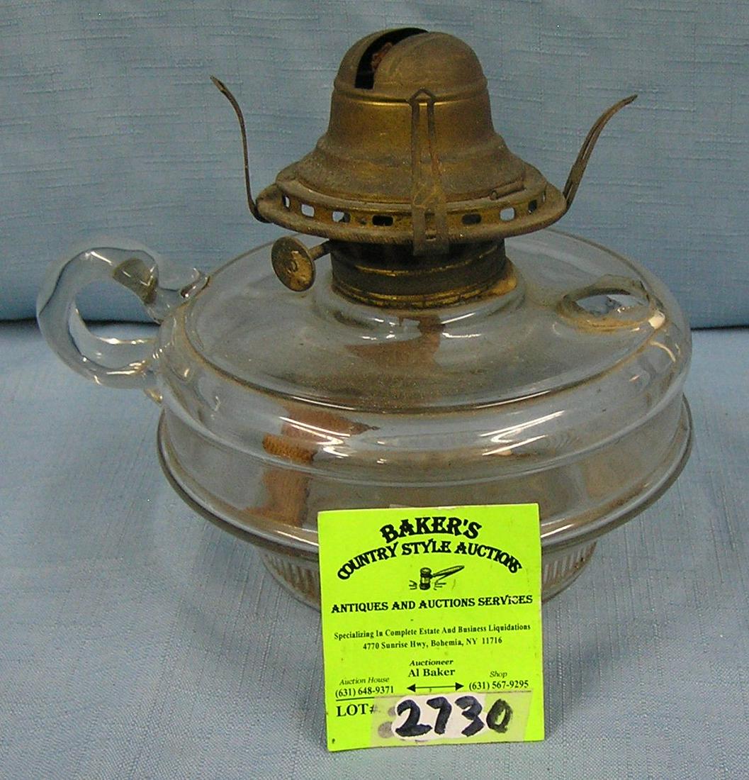 Glass and brass oil lamp: Glass and brass oil lamp condition as found one handle broken est. value $25.00-$30.00