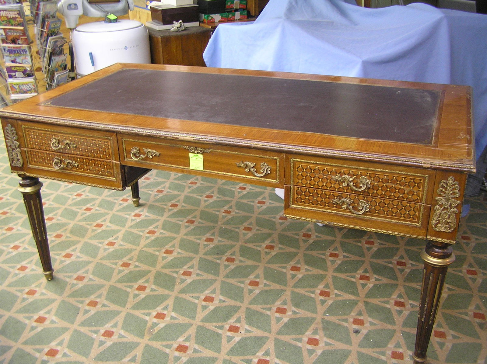 Large antique style English executives desk: Large antique style English executives desk walnut with leather inlaid centerpiece trimmed with loads of brass and frontal inlaid wood 71’’ long by 36’’ deep by 32 ½” high est. value $3500.