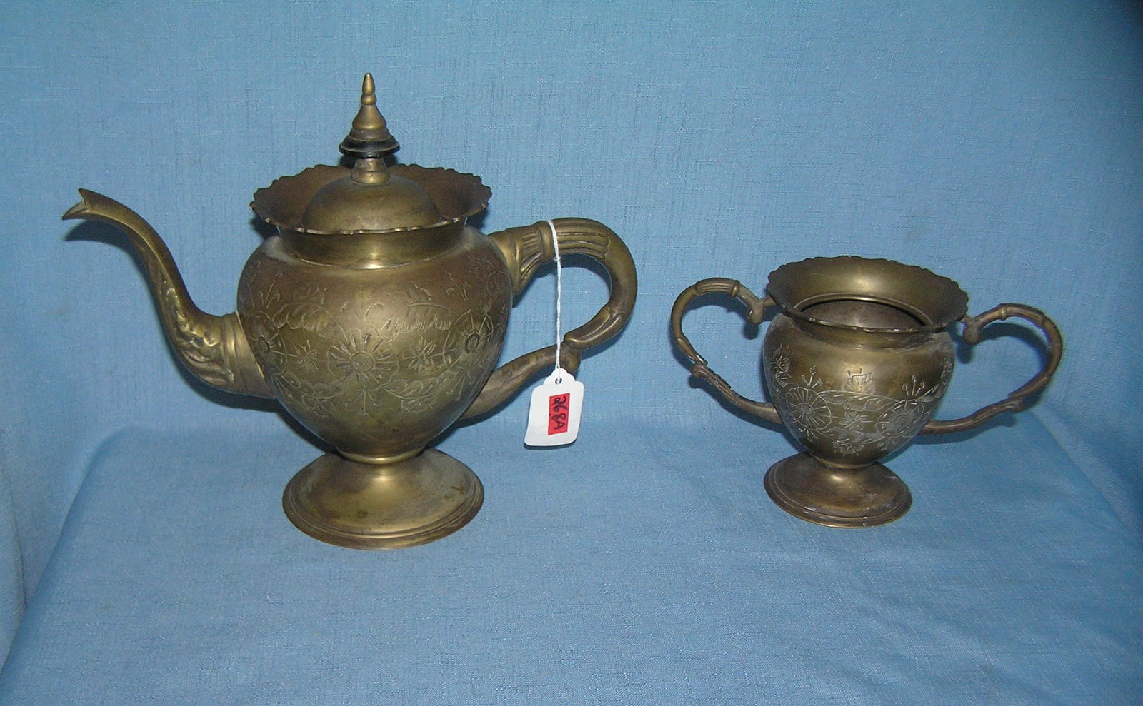Great early coffee pot and 2 handled sugar bowl: Great early brass over silver plate coffee pot and 2 handled sugar bowl wonderful hand cut design throughout both pieces, coffee pot hall marked on base 556 India circa early 1900's est. value $175.00