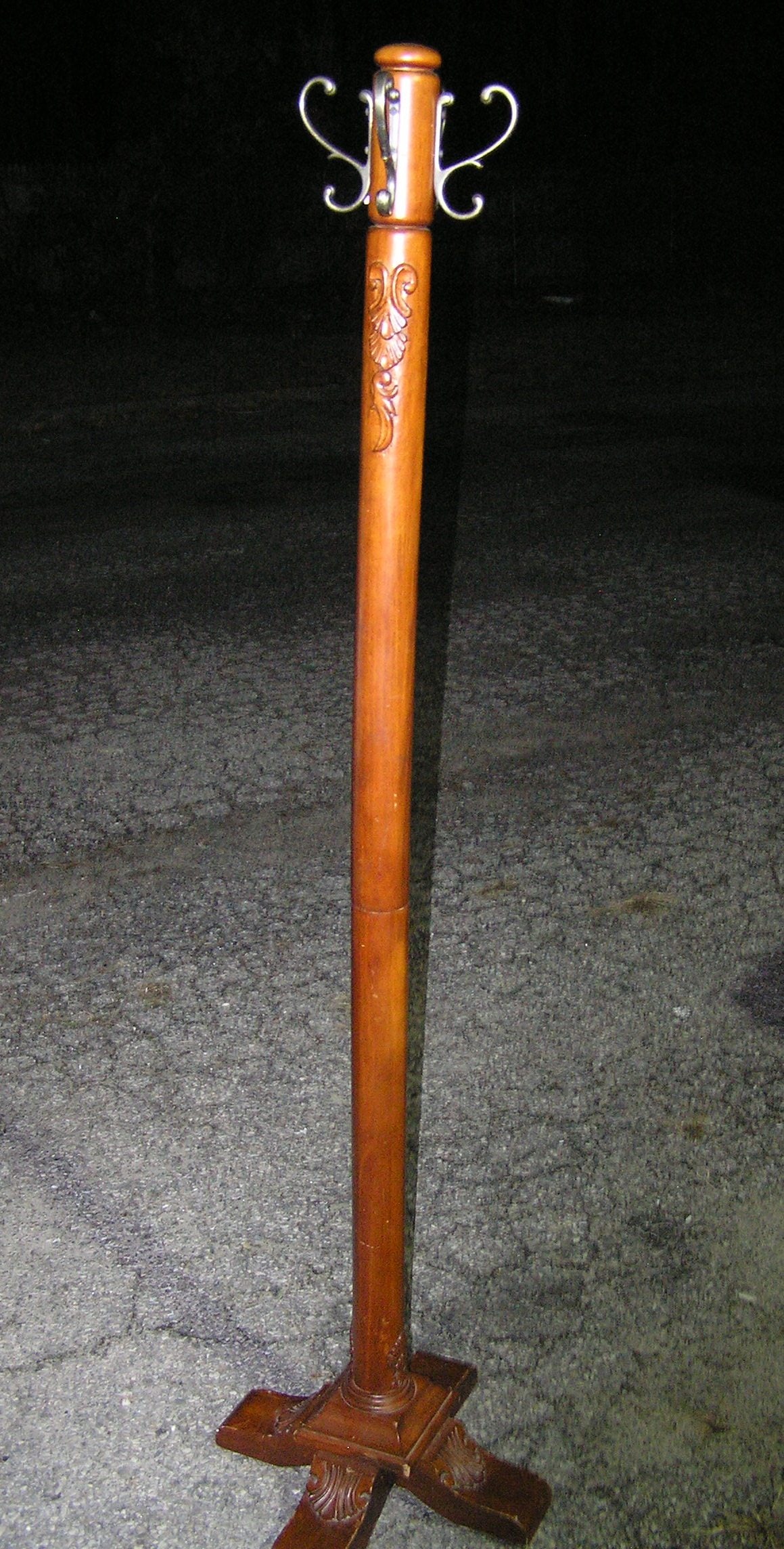 Carved wooden coat rack: Carved wooden coat rack 18 inches wide at base 6 feet tall with brass decorative hooks customer to arrange pickup or delivery of this item est. value $200.00-$300.00