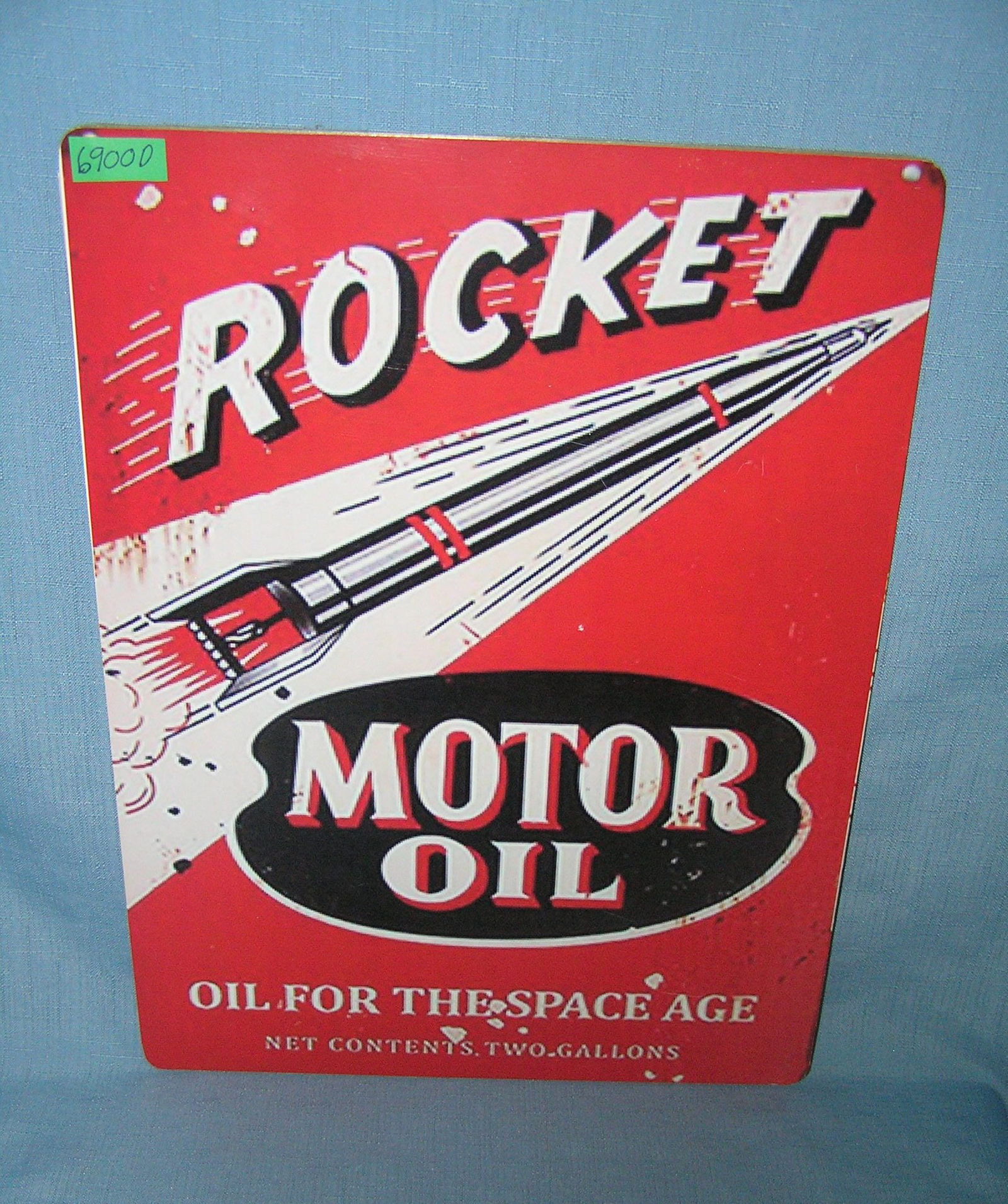 Rocket Motor Oil retro style advertising sign: Rocket Motor Oil retro style advertising sign printed on PVC hardboard these signs are auctioned for their decorative and display purposes 12 inches by 16 inches est. value $50.00-$60.00