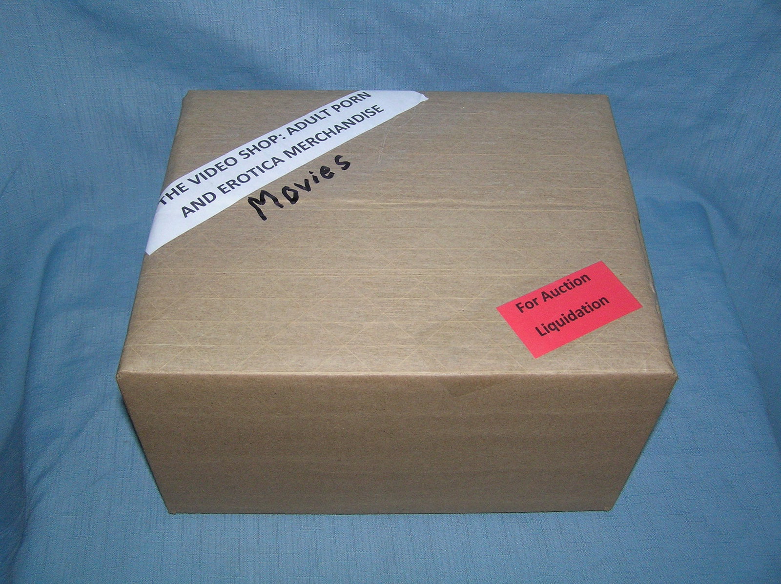Moving and Storage Company mystery box lot marked The Video Shop: Moving and Storage Company mystery box lot marked The Video Shop: Adult Porn and Erotica Movies part of a moving and storage company seized or unclaimed merchandise group sent to auction for liquidati