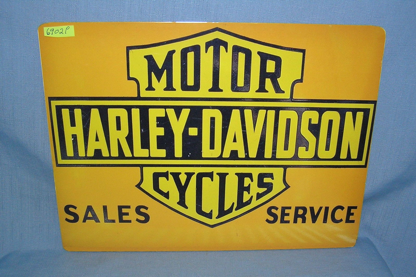 Harley Davidson Motorcycle Sales and Service retro style advertising sign: Harley Davidson Motorcycle Sales and Service retro style advertising sign printed on PVC hardboard these signs are auctioned for their decorative and display purposes 12 inches by 16 inches est. value