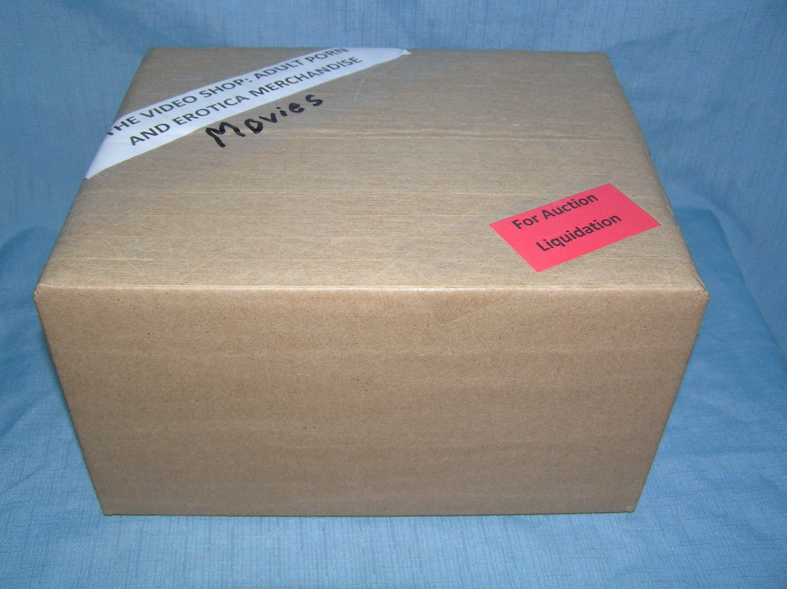 Moving and Storage Company mystery box lot marked The Video Shop: Moving and Storage Company mystery box lot marked The Video Shop: Adult Porn and Erotica Movies part of a moving and storage company seized or unclaimed merchandise group sent to auction for liquidati