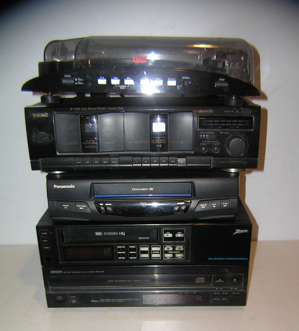 Group of modern electronics: Group of modern electronics includes Ion I Profile turn table, Teac auto reverse double cassette deck, Denon automatic disc loading system, Zenith onscreen programing VHS stereo an dPan asonic omnivis